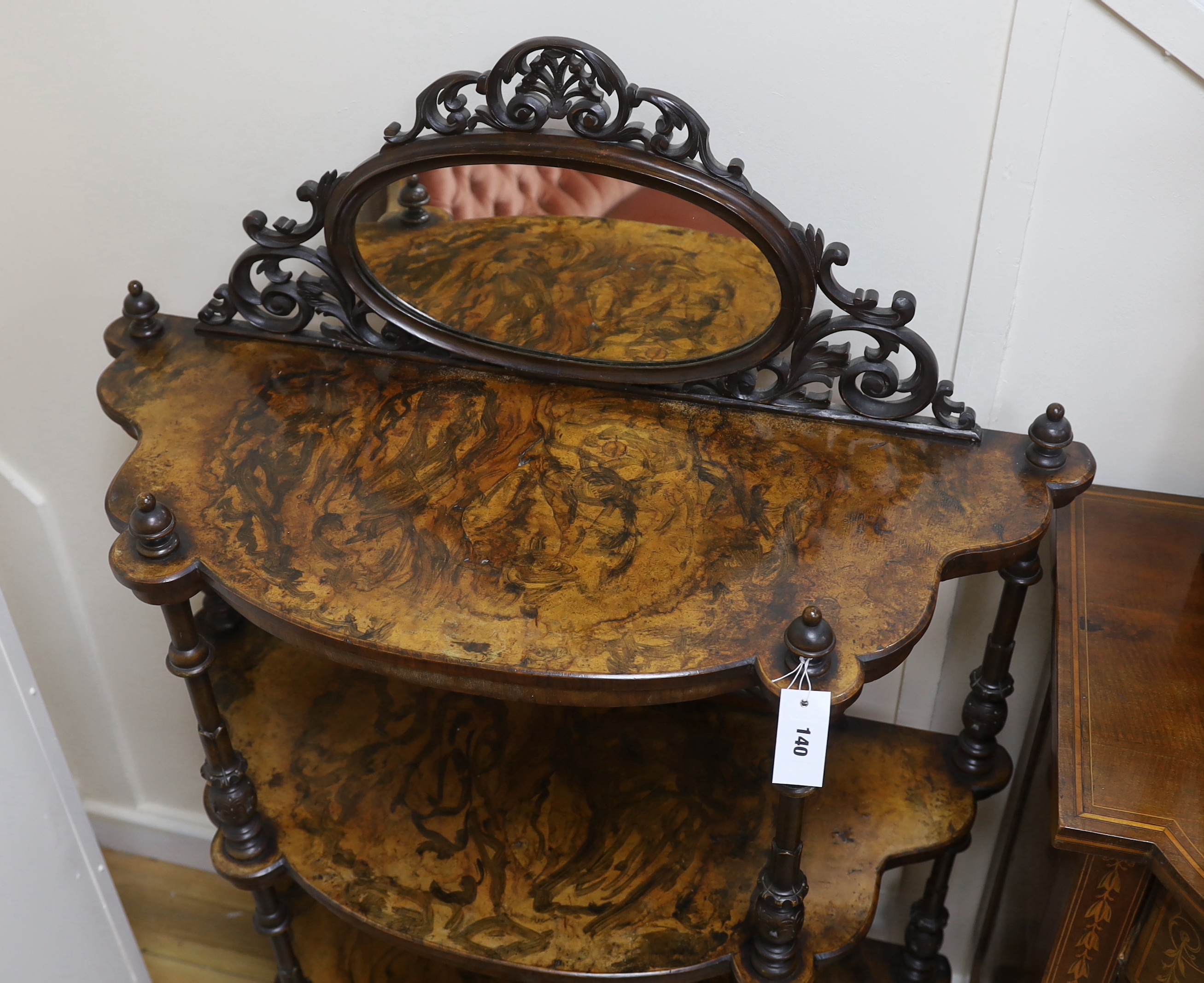 A Victorian walnut and simulated walnut three tier bow front mirror back whatnot, width 93cm, depth 36cm, height 140cm